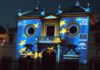 La bandera de Europa recorriendo la fachada de la Maestranza. (FOTO: Javier Martínez)